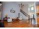 Open-concept living room featuring vaulted ceilings, hardwood floors, and a staircase at 2003 Hubbard Ct, Villa Rica, GA 30180