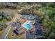 Aerial view featuring a community pool, tennis courts, and lake at 2385 Cape Courage Way, Suwanee, GA 30024
