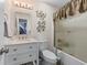 Bright bathroom featuring a vanity with drawers, toilet, and shower with glass doors at 2385 Cape Courage Way, Suwanee, GA 30024