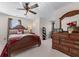 Bedroom features a wooden dresser, bed and double door closet, offering a relaxing atmosphere at 2385 Cape Courage Way, Suwanee, GA 30024