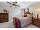 Bedroom features a wooden dresser, bed and double door closet, offering a relaxing atmosphere at 2385 Cape Courage Way, Suwanee, GA 30024