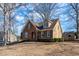 Well-maintained home featuring a brick facade, complemented by neutral siding and professionally landscaped grounds at 2385 Cape Courage Way, Suwanee, GA 30024