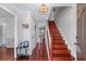 Bright foyer featuring hardwood floors, an elegant staircase, and tasteful decor at 2385 Cape Courage Way, Suwanee, GA 30024