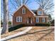 Charming brick home with a manicured lawn, walkway, and a classic architectural design at 2385 Cape Courage Way, Suwanee, GA 30024