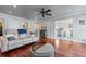 Open living room featuring hardwood floors, comfortable seating, and access to the kitchen at 2385 Cape Courage Way, Suwanee, GA 30024