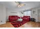 Cozy living room with two red sofas, a glass table, and hardwood floors at 2385 Cape Courage Way, Suwanee, GA 30024