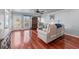 Spacious living room with natural light, hardwood floors, a fireplace and door to outdoor patio at 2385 Cape Courage Way, Suwanee, GA 30024