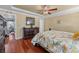 Main bedroom suite features wood floors, trey ceiling, ceiling fan, and walk through to bath at 2385 Cape Courage Way, Suwanee, GA 30024