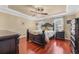 A spacious main bedroom features trey ceilings, hardwood floors, and decorative fan with lighting at 2385 Cape Courage Way, Suwanee, GA 30024