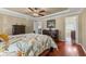 This is a nicely decorated main bedroom with hardwood floors, trey ceiling, and a ceiling fan at 2385 Cape Courage Way, Suwanee, GA 30024