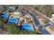 Aerial view of community tennis courts, parking lot, and playground at 325 Morning Mist Walk, Suwanee, GA 30024
