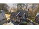 Aerial view of a brick two story home with an attached two car garage at 325 Morning Mist Walk, Suwanee, GA 30024