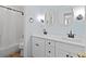 Well-lit bathroom with dual sinks and a shower-tub combo at 325 Morning Mist Walk, Suwanee, GA 30024