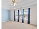 Spacious bedroom with neutral carpet, trey ceiling, large windows, and stylish blue curtains at 325 Morning Mist Walk, Suwanee, GA 30024