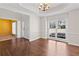 Spacious dining room with hardwood floors, decorative chandelier, and a view into the office at 325 Morning Mist Walk, Suwanee, GA 30024