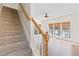 Light-filled stairway with wooden railing, carpeted steps, and windows for plenty of natural light at 325 Morning Mist Walk, Suwanee, GA 30024