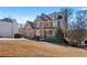 Lovely brick home featuring a two-car garage, covered porch, and a neatly maintained front yard at 325 Morning Mist Walk, Suwanee, GA 30024