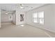 Bright living room featuring neutral carpet, two windows and ceiling fan at 325 Morning Mist Walk, Suwanee, GA 30024