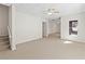 Spacious room with carpet, stairs and ceiling fan offers versatile living space at 325 Morning Mist Walk, Suwanee, GA 30024