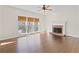 Inviting living room with hardwood floors, a fireplace and large windows offering natural light at 325 Morning Mist Walk, Suwanee, GA 30024