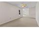 Versatile living room boasting neutral carpet, bright light, and ceiling fan at 325 Morning Mist Walk, Suwanee, GA 30024
