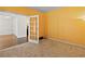 Cozy room with yellow walls, carpeting and french doors leading to an adjacent room with hardwood floors at 325 Morning Mist Walk, Suwanee, GA 30024