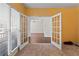Carpeted room with french doors and a large window with blinds offering a view of the adjacent room at 325 Morning Mist Walk, Suwanee, GA 30024