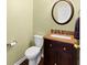 Charming powder room with modern fixtures, granite countertop and a stylish round mirror at 325 Morning Mist Walk, Suwanee, GA 30024