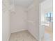 Spacious walk-in closet with wall-mounted shelving for optimal storage at 325 Morning Mist Walk, Suwanee, GA 30024