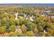 Aerial shot showing the house nestled in a colorful canopy of fall foliage in a quiet neighborhood at 4160 Westchester Ne Xing, Roswell, GA 30075