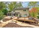 Back exterior showcasing a spacious deck, screened porch, and a well-manicured backyard at 4160 Westchester Ne Xing, Roswell, GA 30075