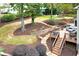 Landscaped backyard featuring a multi-level deck with outdoor seating and stone pathway through the lawn at 4160 Westchester Ne Xing, Roswell, GA 30075