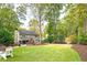 Manicured lawn leading up to the home with a screened porch and patio set at 4160 Westchester Ne Xing, Roswell, GA 30075