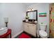 Bathroom with a dark vanity top, a single sink, mirror, and toilet at 4160 Westchester Ne Xing, Roswell, GA 30075