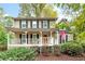 Charming two-story home with a welcoming front porch and meticulously maintained landscaping at 4160 Westchester Ne Xing, Roswell, GA 30075