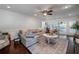 Spacious living room with a large sectional sofa, a ceiling fan, and natural light from sliding glass doors at 4160 Westchester Ne Xing, Roswell, GA 30075