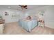 Spacious main bedroom boasts a ceiling fan, wainscoting and natural light from multiple windows at 4160 Westchester Ne Xing, Roswell, GA 30075