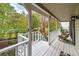 This porch has a wood floor, white railings, and a view of the trees and landscaping at 4160 Westchester Ne Xing, Roswell, GA 30075