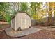 Exterior of an backyard shed with double doors and stone foundation in a landscaped backyard at 4160 Westchester Ne Xing, Roswell, GA 30075