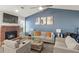 Bright living room with fireplace and sofas, complemented by a vaulted ceiling at 5454 Glen Haven Dr, Atlanta, GA 30349