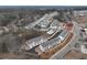 Aerial view of neighborhood with townhomes, landscaping, roads, and a community pool at 1915 Cassia Aly, Kennesaw, GA 30144
