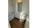 Clean bathroom with a tub and shower combination, white cabinets and wood-look flooring at 1915 Cassia Aly, Kennesaw, GA 30144