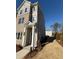 Charming townhome featuring brick facade, gray siding, and well-manicured landscaping at 1915 Cassia Aly, Kennesaw, GA 30144