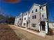 View of new brick townhome exteriors with gray shutters and covered entryways at 1915 Cassia Aly, Kennesaw, GA 30144