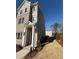 Side view of newly built townhome featuring a brick facade, covered entryway, and modern design at 1915 Cassia Aly, Kennesaw, GA 30144