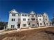 Beautiful townhomes featuring brick facade, gray siding, and well-manicured landscaping at 1915 Cassia Aly, Kennesaw, GA 30144