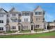 New townhome complex with modern architectural design, featuring brick and gray accents under a clear sky at 1915 Cassia Aly, Kennesaw, GA 30144