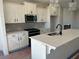 Well-lit kitchen featuring white cabinets, stainless steel appliances, and quartz countertops at 1915 Cassia Aly, Kennesaw, GA 30144