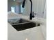 Close-up of a kitchen sink with a modern black faucet and bright countertops at 1915 Cassia Aly, Kennesaw, GA 30144