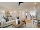 Well-lit living room connected to kitchen, featuring modern furnishings and hardwood floors at 1915 Cassia Aly, Kennesaw, GA 30144